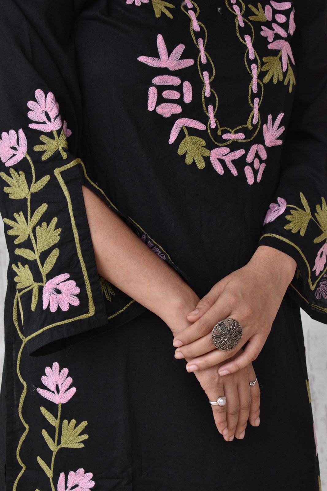 Model wearing an embroidered tunic dress