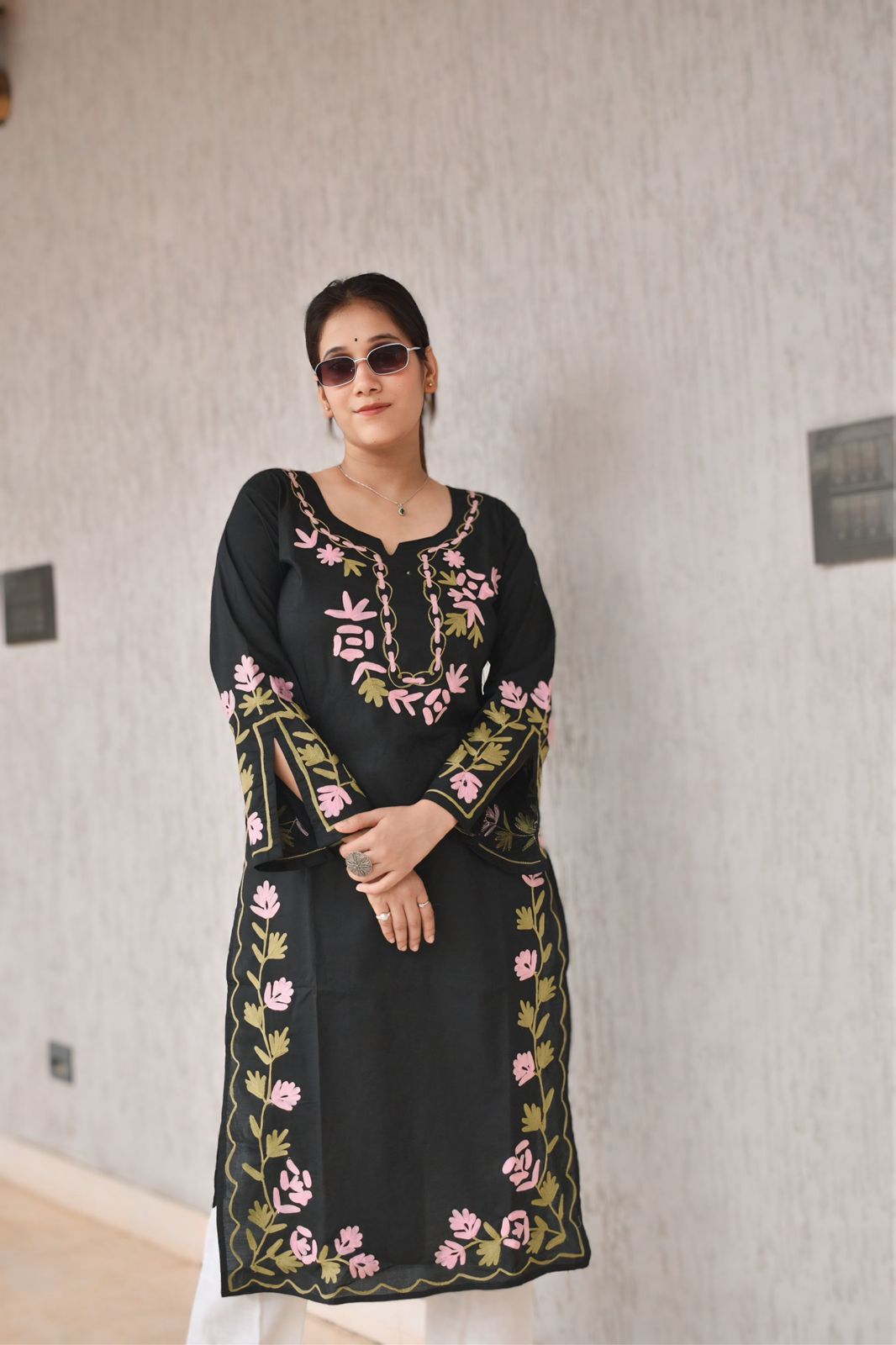 Model wearing an embroidered tunic dress